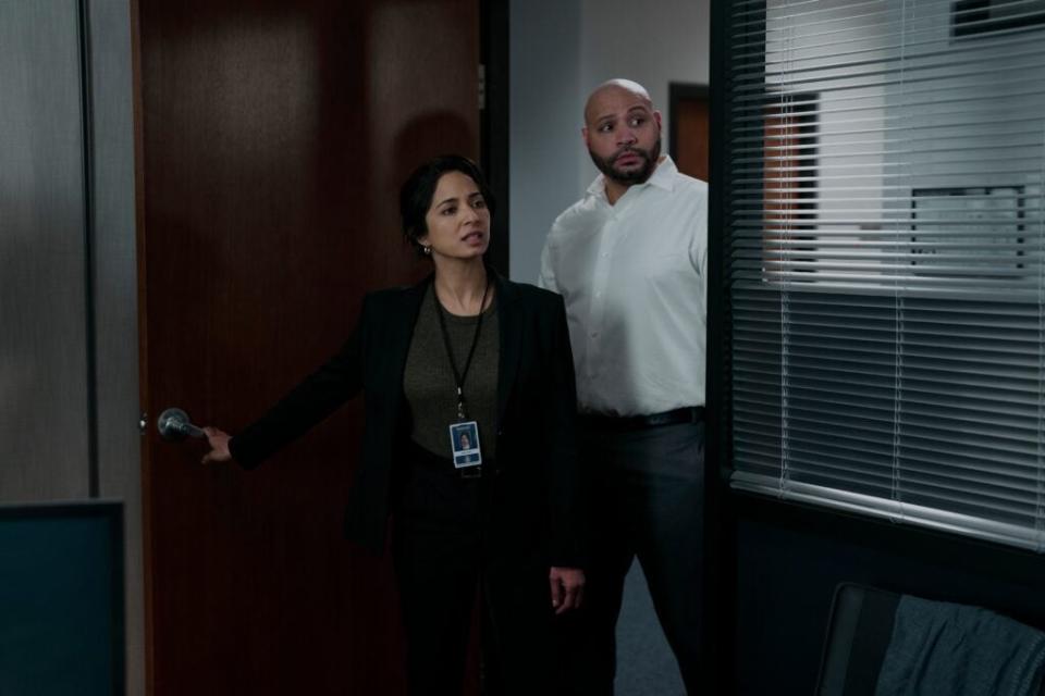 The Recruit. (L to R) Aarti Mann as Violet Ebner, Colton Dunn as Lester Kitchens in episode 102 of The Recruit. Cr. Philippe Bossé/Netflix © 2022