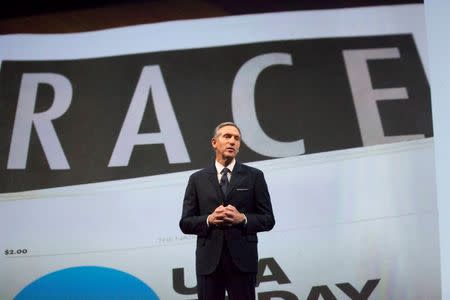 Starbucks Corp Chief Executive Howard Schultz, pictured with images from the company's new "Race Together" project behind him, speaks during the company's annual shareholder's meeting in Seattle, Washington March 18, 2015. REUTERS/David Ryder