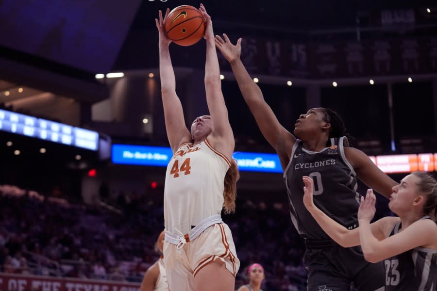 Texas forward Taylor Jones (44) grabs a rebound over Iowa State center Isnelle Natabou (0) and guard Kelsey Joens (23) during the first half of an NCAA college basketball game in Austin, Texas, Saturday, Feb. 17, 2024. (AP Photo/Eric Gay)