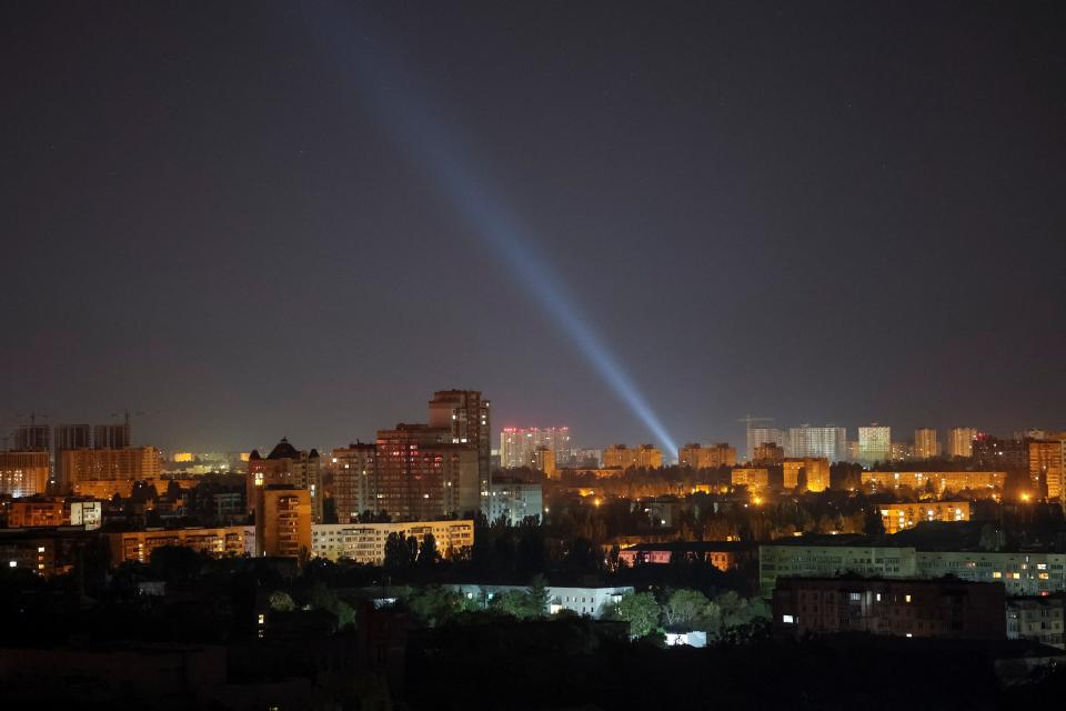 A Ukrainian searchlight scours the night sky for Russian drones on Monday (REUTERS)