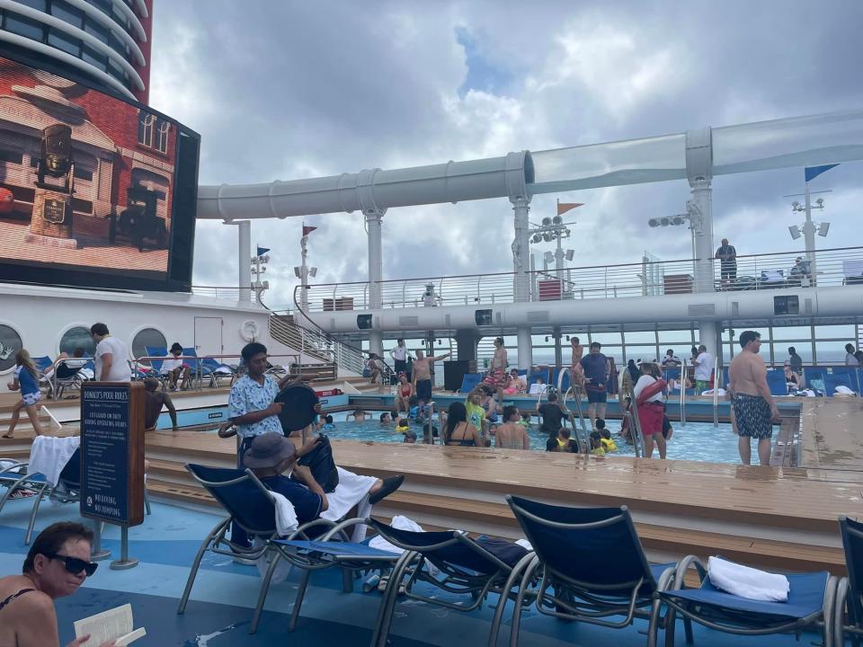 crowded pool and pool deck on disney cruise