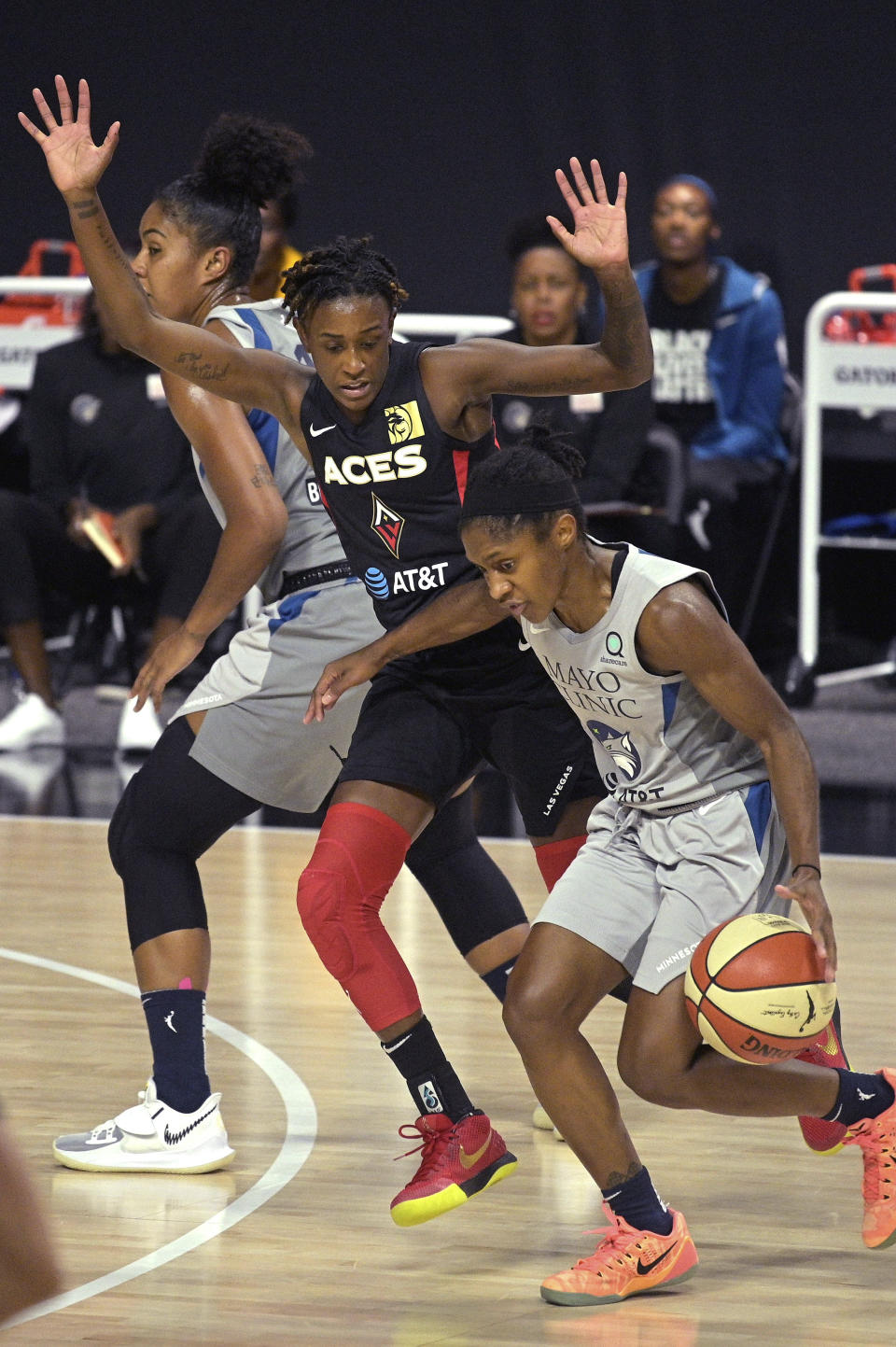 Minnesota Lynx guard Crystal Dangerfield, right, is fouled by Las Vegas Aces guard Danielle Robinson while driving to the basket during the first half of a WNBA basketball game Thursday, Sept. 10, 2020, in Bradenton, Fla. (AP Photo/Phelan M. Ebenhack)