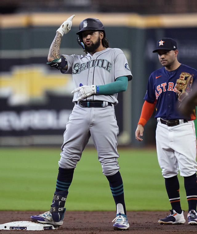 Houston Astros fans hold signs supporting second baseman Jose Altuve (27)  and designated hitter Yordan Alvarez before a baseball game between the  Seattle Mariners and the Astros, Friday, July 22, 2022, in