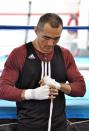 In this photo taken April 5, 2014, WBA and IBA light heavyweight boxing champion Beibut Shumenov, of Kazakhstan, tapes his hands for a workout in Las Vegas. Shumenov and IBF light heavyweight champion Bernard Hopkins will fight at the DC Armory on Saturday, April 19. (AP Photo/Joe Coomber)