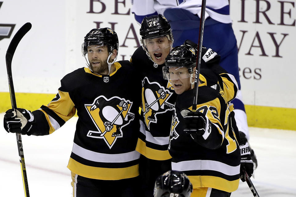 Pittsburgh Penguins' Evgeni Malkin (71) celebrates his goal with Bryan Rust (17) and Patric Hornqvist (72) during the first period of an NHL hockey game against the Tampa Bay Lightning in Pittsburgh, Tuesday, Feb. 11, 2020. (AP Photo/Gene J. Puskar)