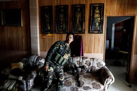 A Filipino stands in a house used as combat position as government troops continue their assault against insurgents from the Maute group in Marawi city, Philippines July 1, 2017. REUTERS/Jorge Silva