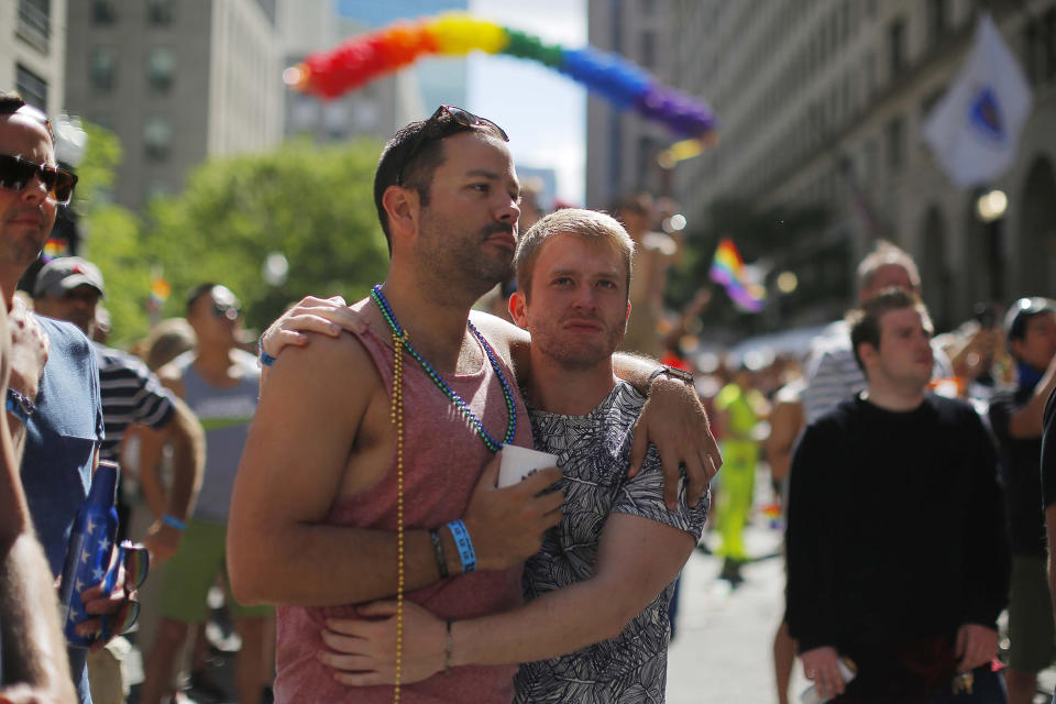 <p>Chris Hemming (L) and Tristan Davison join in a moment of silence for the victims of the mass shooting at Orlando’s Pulse nightclub during a Pride Month block party in Boston, Massachusetts, June 12, 2016. (REUTERS/Brian Snyder) </p>