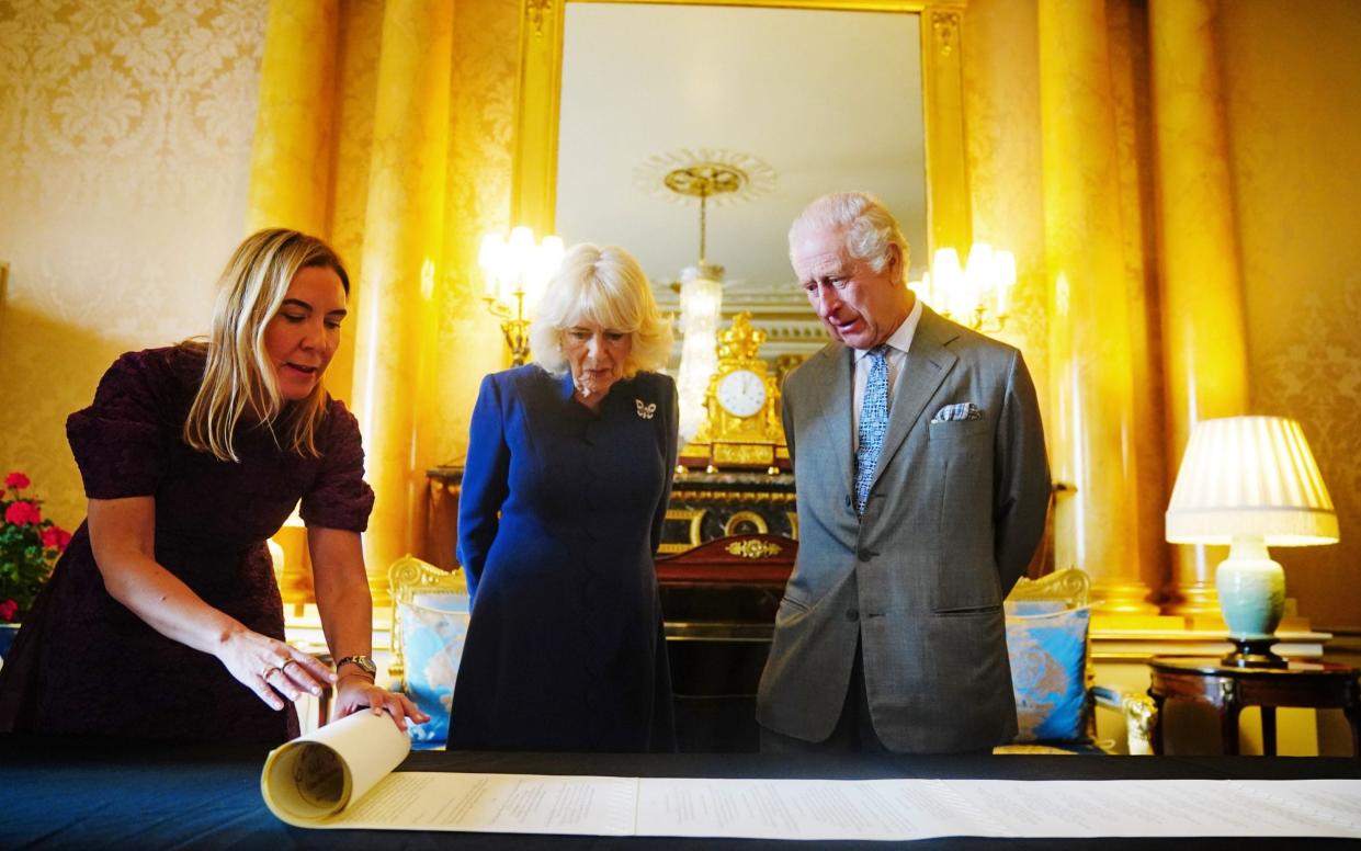 Antonia Romeo, the clerk of the Crown in Chancery, unfurls the 211-metre Coronation Roll for King Charles and Queen Camilla