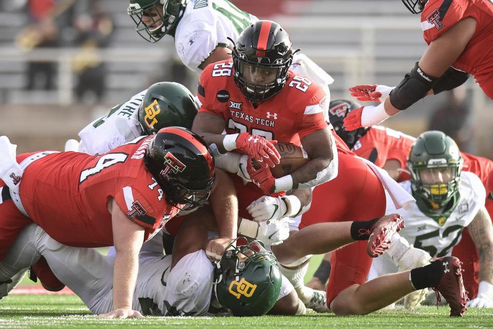 Texas Tech running back Tahj Brooks (28) is brought down on a run against Baylor during an NCAA college football game in Lubbock, Texas, Saturday, Nov. 14, 2020. (AP Photo/Justin Rex)