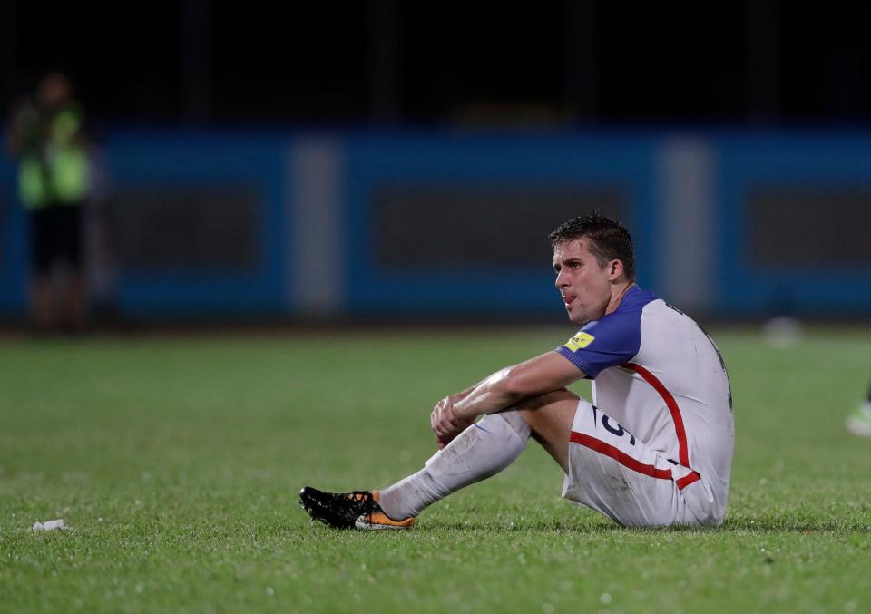 Matt Besler, of the United States, sits on the pitch after losing 2-1 against Trinidad and Tobago during a 2018 World Cup qualifying soccer match in Couva, Trinidad & Tobago.