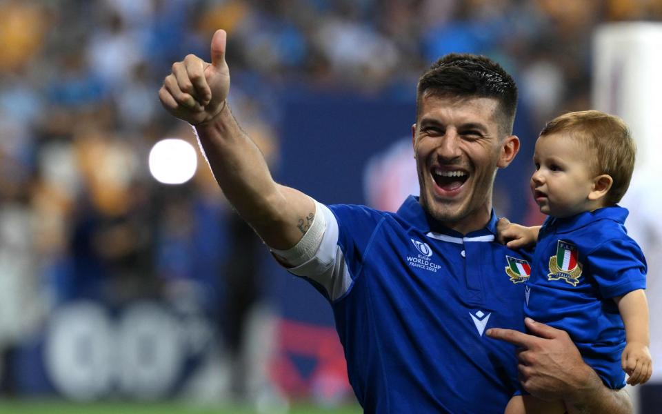 Italy's fly-half Tommaso Allan gives a thumbs up as he celebrates Italy's victory