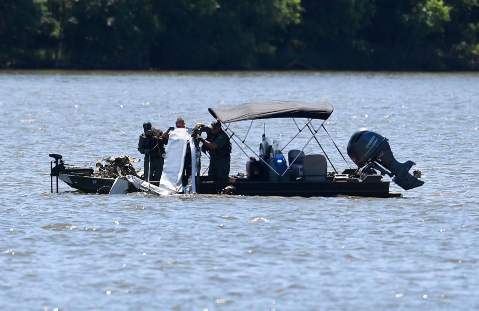 Emergency personnel remove debris of a plane crash from J. Percy Priest Lake near Fate Sanders boat ramp Sunday, May 30, 2021 in Smyrna, Tenn. Seven people are presumed dead after the small plane crashed into the lake on Saturday, while it was heading from Smyrna to Palm Beach International Airport in Florida.