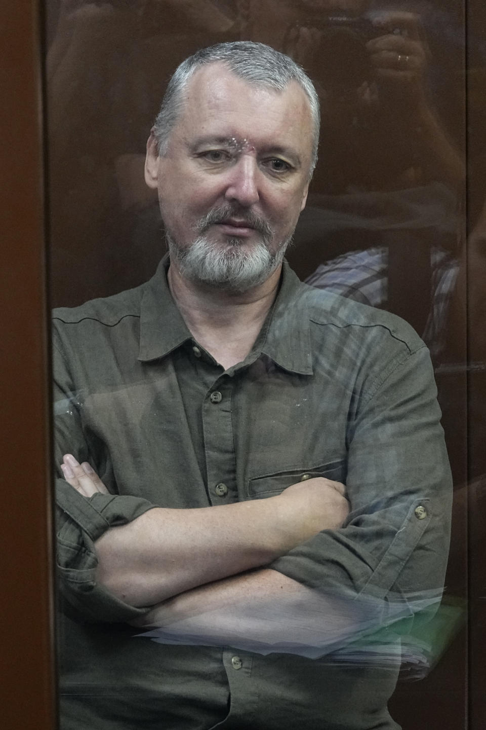 Igor Girkin also know as Igor Strelkov, the former military chief for Russia-backed separatists in eastern Ukraine, sits in a glass cage in a courtroom at the Moscow's Meshchansky District Court in Moscow, Russia, Friday, July 21, 2023. A prominent Russian hard-line nationalist who accused President Vladimir Putin of weakness and indecision in Ukraine was detained Friday on charges of extremism, a signal the Kremlin has toughened its approach with hawkish critics after last month's abortive rebellion by the Wagner mercenary company. (AP Photo/Alexander Zemlianichenko, Pool)