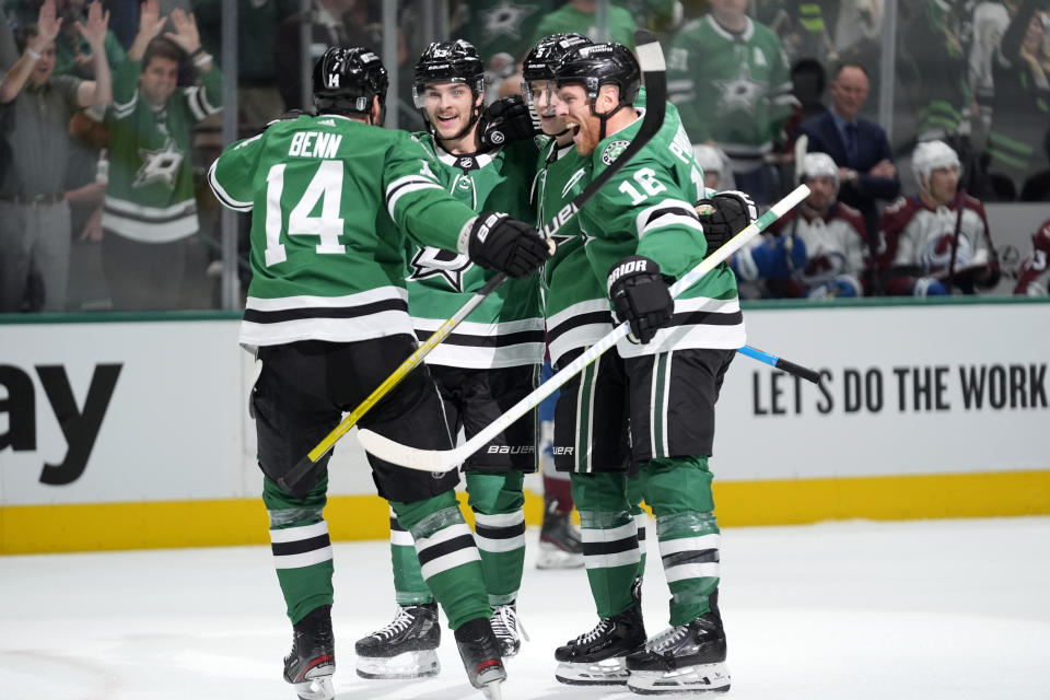 Dallas Stars' Jamie Benn (14), Wyatt Johnston, from left rear, Nils Lundkvist and Joe Pavelski (16) celebrate after Johnston scored in the first period in Game 2 of an NHL hockey Stanley Cup second-round playoff series against the Colorado Avalanche in Dallas, Tuesday, May 7, 2024. (AP Photo/LM Otero)