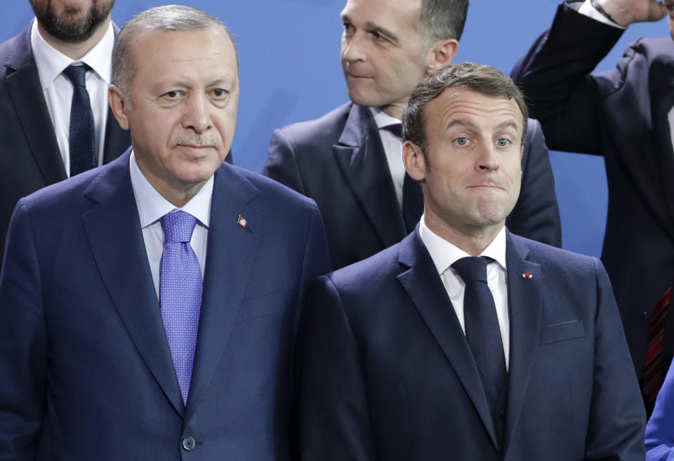 FILE - In this Sunday, Jan. 20, 2020 file photo, Turkey's President Recep Tayyip Erdogan, left and French President Emmanuel Macron stand, during a group photo at a conference on Libya at the chancellery in Berlin, Germany. France has recalled its ambassador to Turkey after Turkish President Recep Tayyip Erdogan said President Emmanuel Macron needed mental health treatment and made other comments that the French government described as unacceptably rude. Erdogan questioned his French counterpart’s mental condition while criticizing Macron’s attitude toward Islam and Muslims. (AP Photo/Michael Sohn, File)