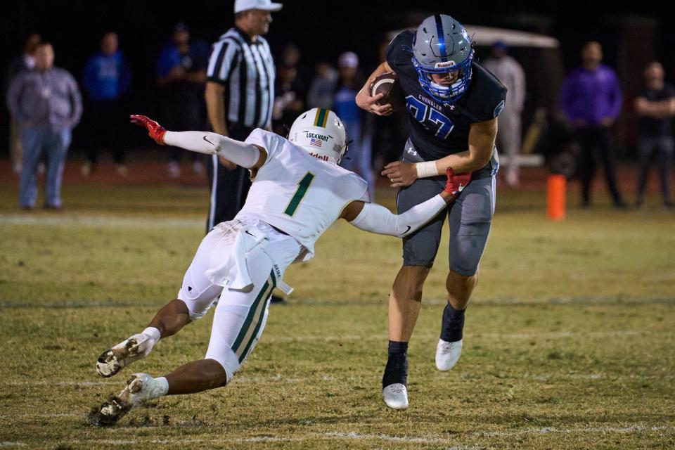 Chandler Wolves quarterback Kaden Anderson (87) rushes the ball as Basha Bears cornerback Miles Lockhart (1) lunges for a tackle at Austin Field in Chandler on Friday, Oct. 28, 2022.