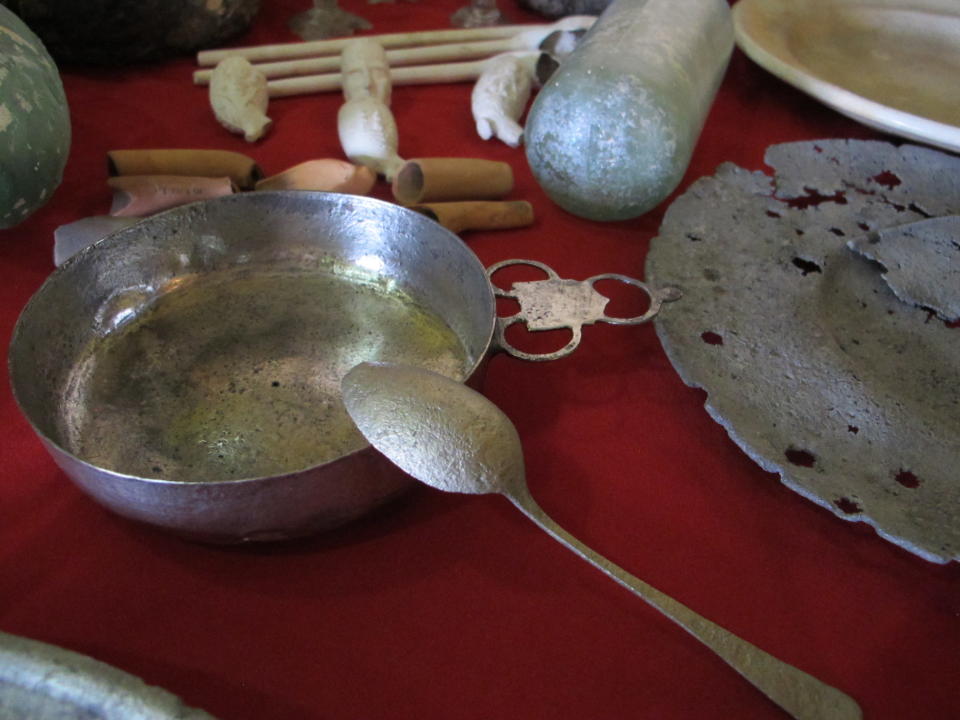 Silver forks, pewter cups, ceramic dishes, ornate smoking pipes and other artifacts collected by underwater archaeologists from the remains of the submerged Jamaican city of Port Royal, are shown to the media during a press conference in Port Royal, Jamaica, Tuesday, May 29, 2012. A team of international archaeologists said Tuesday that they’ll ask the United Nations’ cultural agency to bestow world heritage status on Port Royal, the mostly submerged remains of a historic Jamaican port known as the “wickedest city on Earth” more than three centuries ago. (AP Photo/David McFadden)