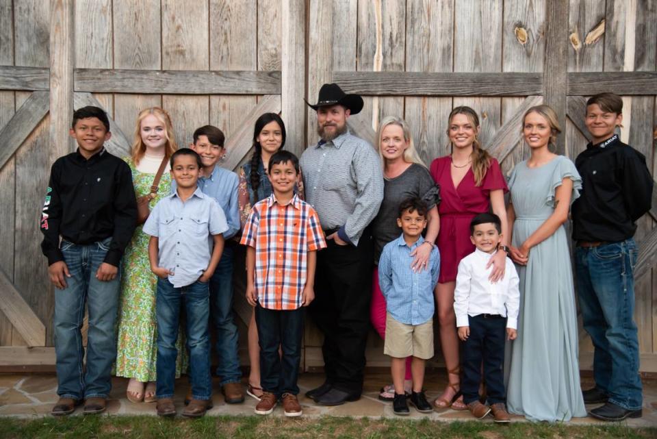 Angela and Elliott Turbeville, formerly of Columbus, now living on their Marion County farm, pose for a photo with their three biological children, seven adopted children and one grandchild.