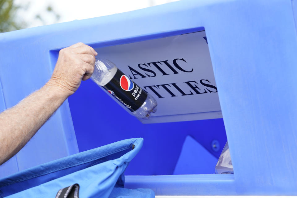 IMAGE DISTRIBUTED FOR PEPSICO BEVERAGES NORTH AMERICA - A Walmart shopper recycles a bottle of Pepsi as part of a campaign co-sponsored by PepsiCo and Walmart as part of a joint effort to increase recycling rates of plastic, glass and aluminum beverage containers locally on Friday, Oct. 22, 2021 in Tulsa, Okla. Shoppers who bring their beverage containers to be recycled at the Walmart stores on 71st Street and Memorial Drive, and 111th Street and Memorial Drive, as well as the Sam's Clubs in Tulsa Hills and Sheridan, will be presented with opportunities to win free rewards and exciting prizes like Super Bowl tickets. Scaled nationally and globally, local efforts like these support a circular economy and help advance the shared missions of PepsiCo, Walmart, and Sam's Club to achieve 100% recyclable or compostable packaging by 2025. (Nick Oxford/AP Images for PepsiCo Beverages North America)