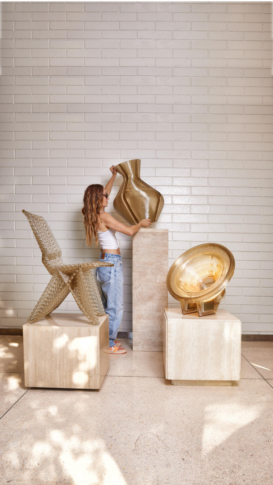 Tiled room with chair, sculpture, and woman holding a vase