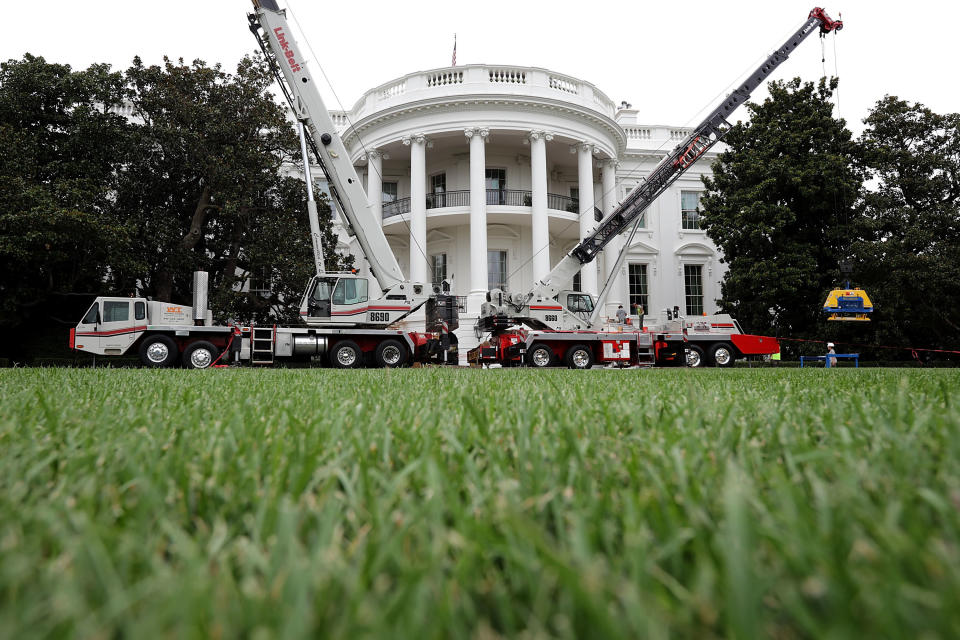 Construction cranes work to repair the South Portico steps.