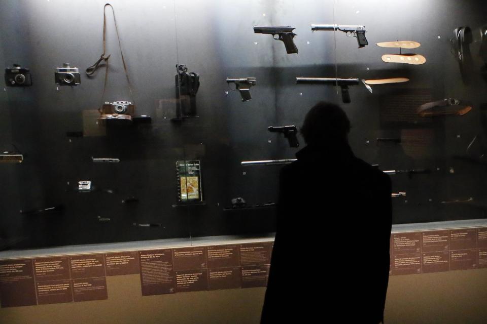 A visitor looks at real-life spy gadgets and weapons of secret agents around the world displayed as part of the 'Secret Wars' exhibition at Invalides Museum, in Paris, Monday, Dec. 12, 2016. (AP Photo/Francois Mori)