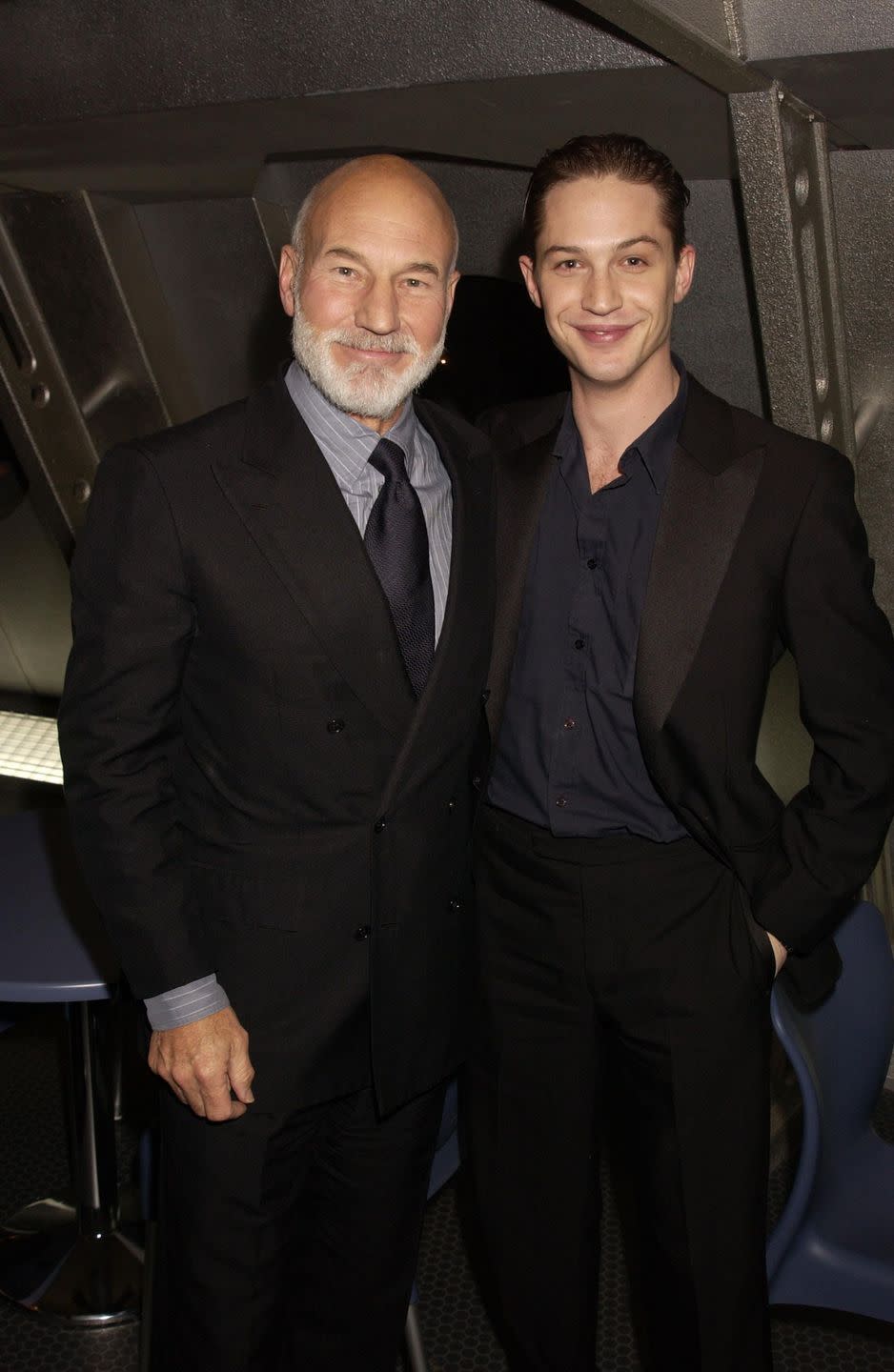 patrick stewart and tom hardy smile on the red carpet at a star trek movie premiere in 2002