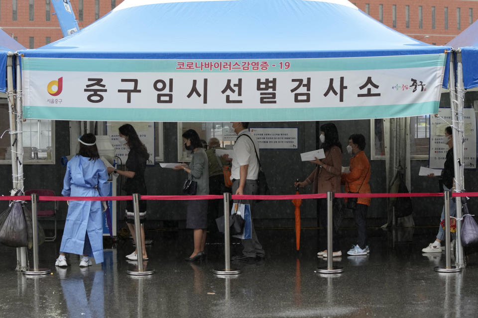 People wait to get coronavirus testing at a makeshift testing site in Seoul, South Korea, Tuesday, Sept. 7, 2021. The banner reads: "The COVID-19 makeshift testing site." (AP Photo/Ahn Young-joon)