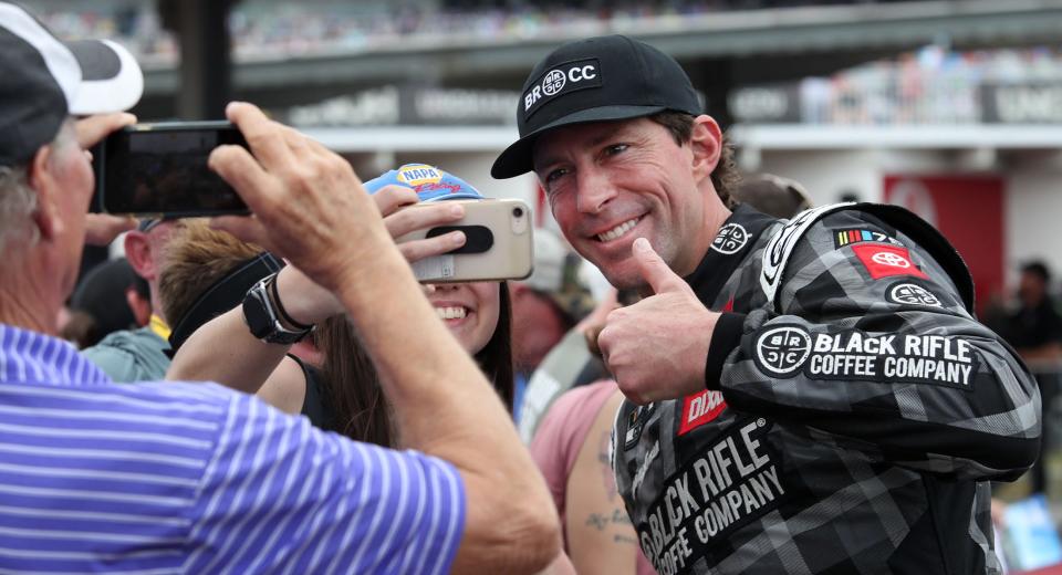 Travis Pastrana takes photos with fans as he comes off the red carpet on his way to the drivers meeting, Sunday, Feb. 19, 2023 before the start of the Daytona 500.