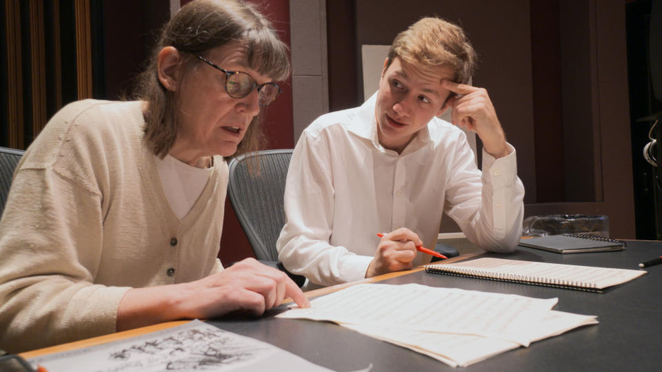 This Nov. 7, 2018, photo provided by the University of Michigan shows Professor Patricia Hall and graduate student Joshua Devries reviewing the music manuscript for "The Most Beautiful Time of Life" at the Duderstadt Center recording studio on campus in Ann Arbor, Mich. The Contemporary Directions Ensemble in October 2018 recorded the music, as it's translated from German to English. It will perform the piece Friday, Nov. 30, 2018, during a free on-campus concert. The music has not been heard since it was arranged and performed by prisoners in a World War II death camp. (Christopher Boyes/University of Michigan via AP)