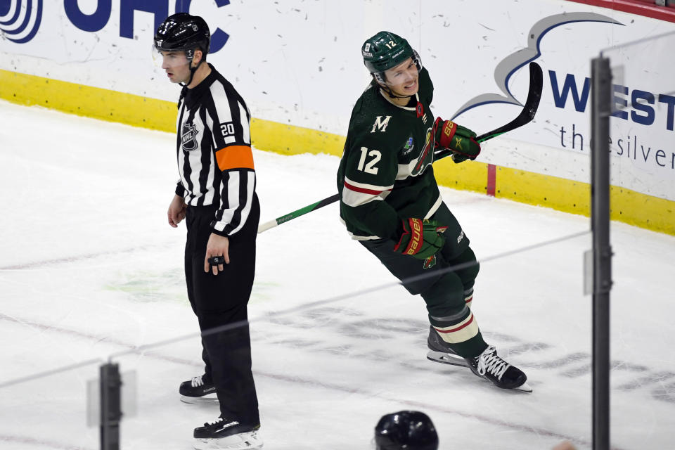 Minnesota Wild left wing Matt Boldy (12) celebrates after scoring the winning goal against the Anaheim Ducks as he skates past referee Mitch Dunning during a shootout in an NHL hockey game Saturday, Dec. 3, 2022, in St. Paul, Minn. (AP Photo/Craig Lassig)