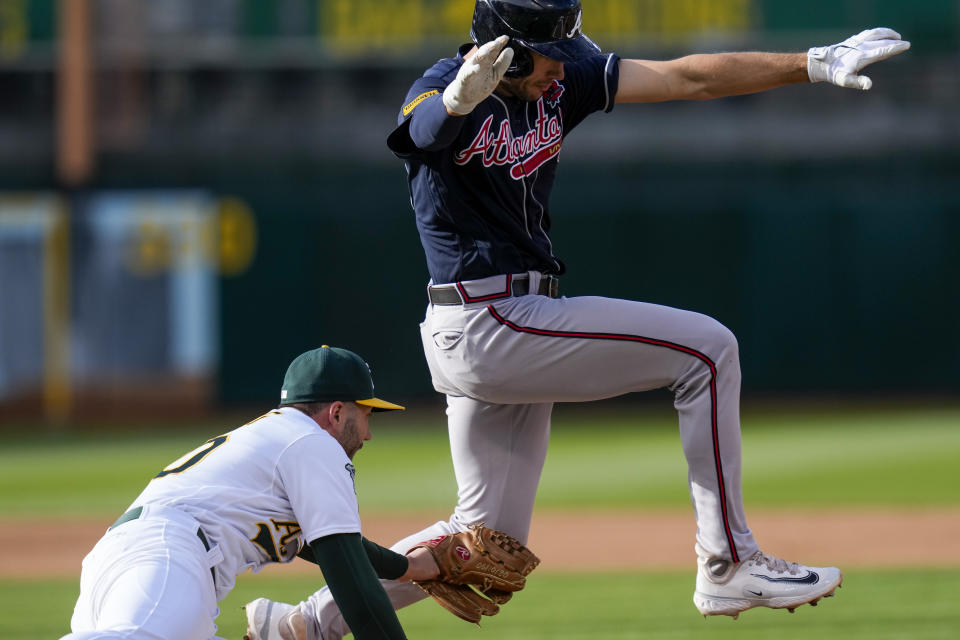 Oakland Athletics pitcher Lucas Erceg, left, tags out Atlanta Braves' Matt Olson during the fifth inning of a baseball game in Oakland, Calif., Monday, May 29, 2023. (AP Photo/Godofredo A. Vásquez)