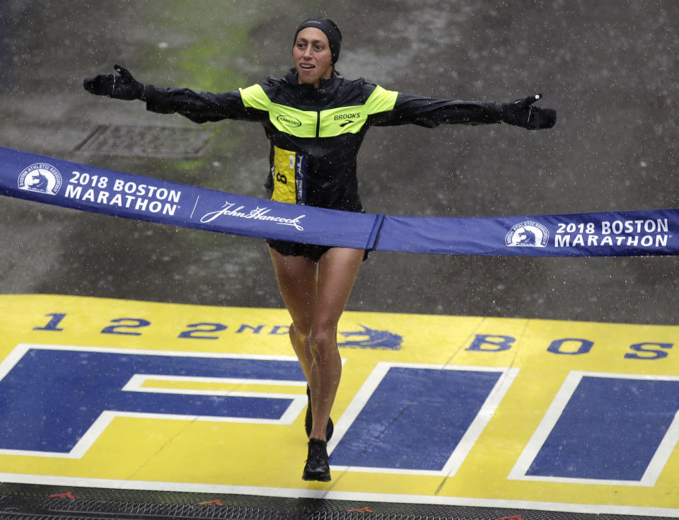 FILE- In this April 16, 2018, file photo, Desiree Linden, of Washington, Mich., crosses the finish line to win the women's division of the 122nd Boston Marathon in Boston. Footwear will be a the forefront at the U.S. Olympic marathon trials this weekend in Atlanta. No matter what time the marathoners turn in or how well they run, the they know their shoes will be the real headliner. (AP Photo/Charles Krupa, File)