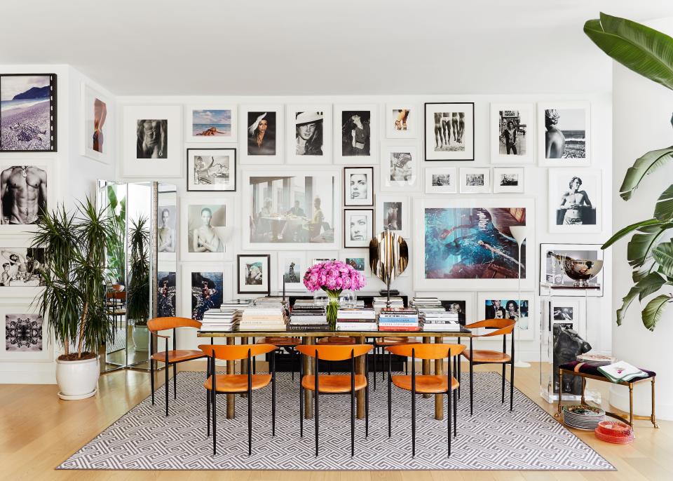 “In Milan, I’ve had mirrored walls everywhere—it just doubles the size. And we are obsessed with this vintage mirrored screen. By putting it in the dining room, we can bring the skyline view right to the table,” says Atwood. Both the dining room table and chairs are vintage, and while the couple does entertain, the table doubles as a library of sorts. Explains Deutsch, “It’s modern living here, and we eat at the bar in the kitchen 90% of the time.” Vintage Versace plates are on display, as well. (Atwood was once head of accessories design at the storied house.)