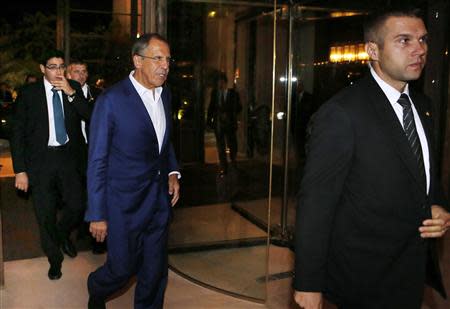 Russian Foreign Minister Sergey Lavrov (C) arrives at a hotel for a late continuation of meetings with U.S. Secretary of State John Kerry (not seen) about the ongoing problems in Syria, in Geneva September 13, 2013. REUTERS/Larry Downing