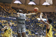 West Virginia forward Derek Culver (1) goes to make a shot as he is defended by Missouri forward Reed Nikko (14) and guard Torrence Watson (0) during the second half of an NCAA college basketball game Saturday, Jan. 25, 2020, in Morgantown, W.Va. (AP Photo/Kathleen Batten)