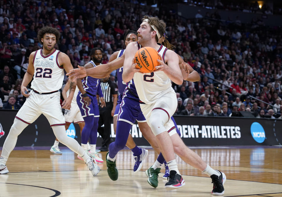 Gonzaga forward Drew Timme, front, drives past TCU forward Xavier Cork in the first half of a second-round college basketball game in the men's NCAA Tournament on Sunday, March 19, 2023, in Denver. (AP Photo/John Leyba)
