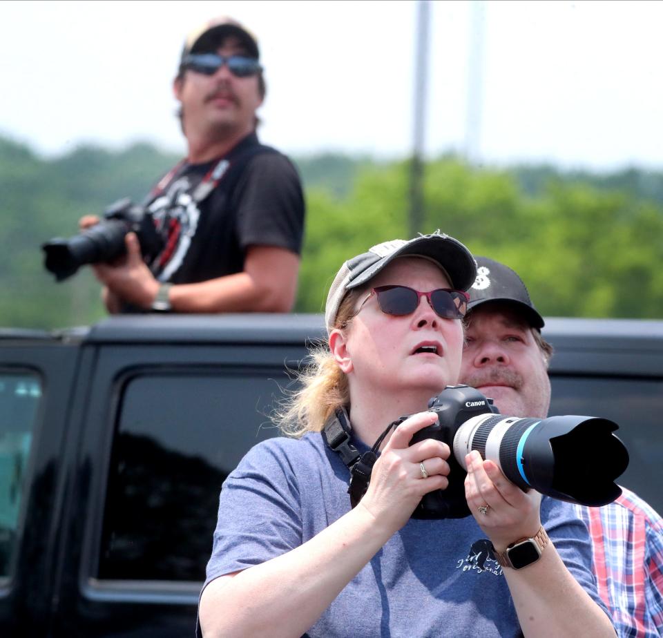 Misty Shupe of Knoxville takes photos of the U.S. Navy Blue Angels, a flight demonstration squadron as her husband Stephen Shupe stands with her and Nick Stansbury of La Vergne takes pics out of the sunroof of his vehicle on Thursday, June 8, 2023, as the Blue Angels practice for The Great Tennessee Air Show this weekend. 