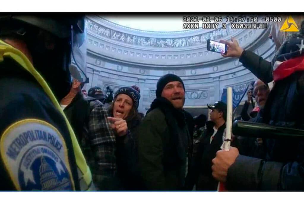 This image from Metropolitan Police Department body worm camera video and contained in the Statement of Facts supporting an arrest warrant for Pauline Bauer, pointing second to left, taken in the Rotunda of the U.S. Capitol on Jan. 6, 2021, in Washington. (Justice Department via AP)
