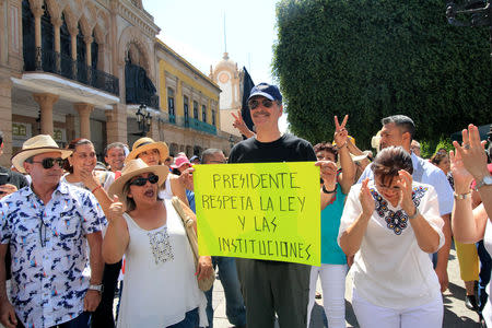 Former Mexican President Vicente Fox holds a sign in a march against the government of Mexico's President Andres Manuel Lopez Obrador in Leon, in Guanajuato state, Mexico May 5, 2019. The sign reads, "President, respect the law and institutions". REUTERS/Mario Armas