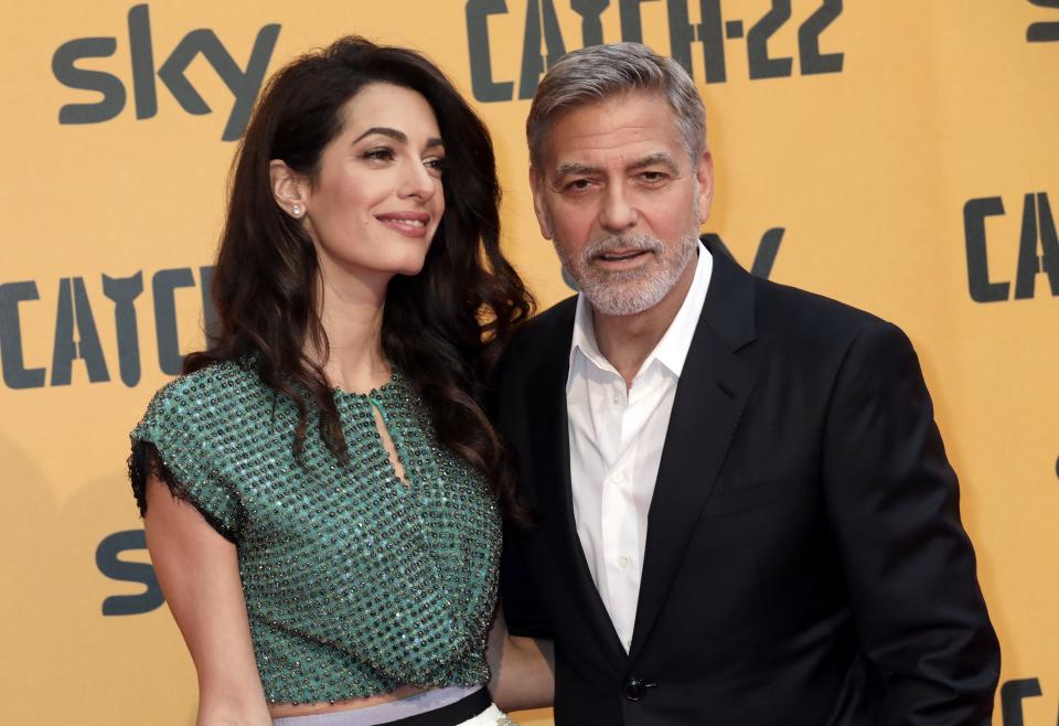 George Clooney, right, seen with his wife, Amal Clooney, at a 2019 premiere, says Amal is watching "ER" episodes and is not impressed with the behavior of his character, Dr. Doug Ross.