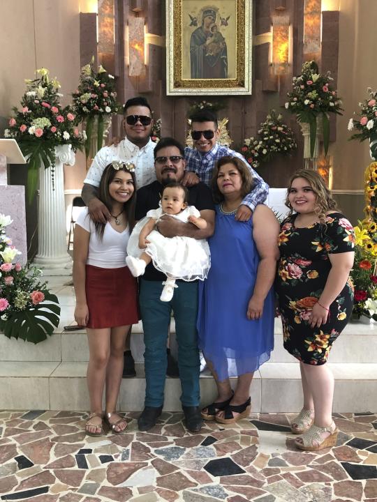 The Martinez Family of West Liberty, Iowa is pictured in June 2019 in the town of Ignacio Allende, Mexico. The coronavirus has swept through the family in the last three weeks. Jose Gabriel Martinez, holding his granddaughter in the center of the photo, died on Tuesday, April 21, 2020, at age 58. Aurelia Martinez, second from right, tested positive on April 3 but has recovered. Their 22-year-old daughter Evelyn, bottom right, has been hospitalized since April 10. Evelyn's older brother, Omar Martinez, top left, says the experience has been devastating. (Martinez Family via AP)