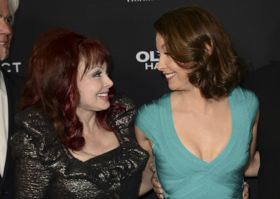 FILE - Ashley Judd, right, and her mother, Naomi Judd, arrive at the LA premiere of "Olympus Has Fallen," at the ArcLight Theatre, Monday, March 18, 2013, in Los Angeles. Naomi Judd, the Kentucky-born matriarch of the Grammy-winning duo The Judds and mother of Wynonna and Ashley Judd, has died, her family announced Saturday, April 30, 2022. She was 76. (Photo by Jordan Strauss/Invision/AP, File)