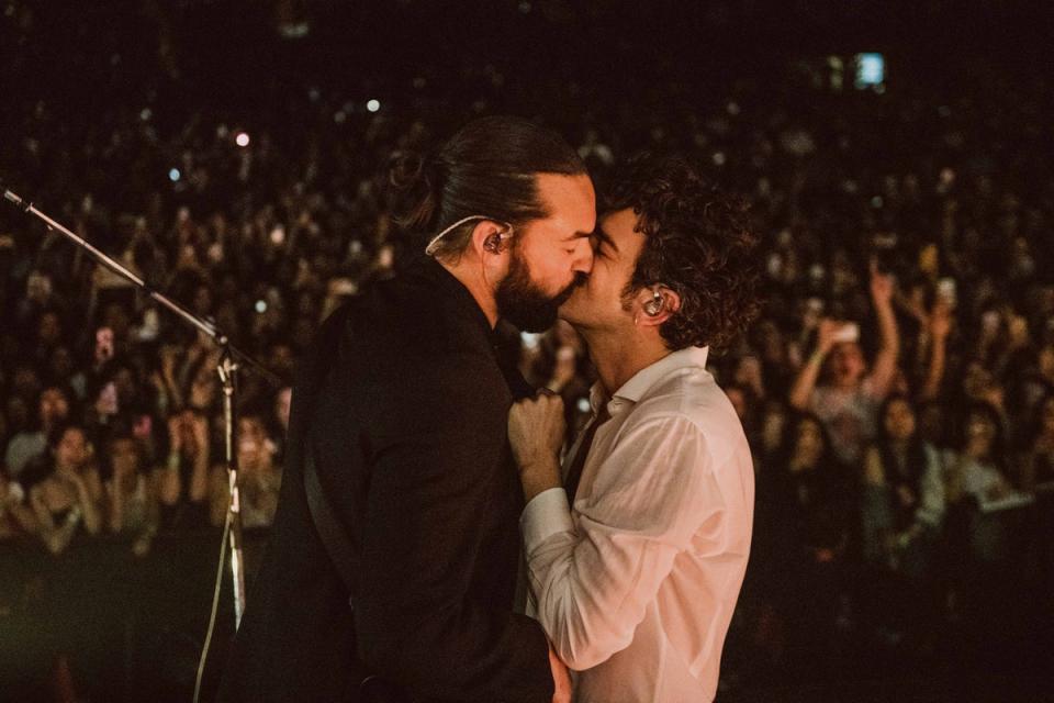 Matty Healy (right) kisses Ross MacDonald on stage at the Kia Forum, Los Angeles (Jordan Curtis Hughes)