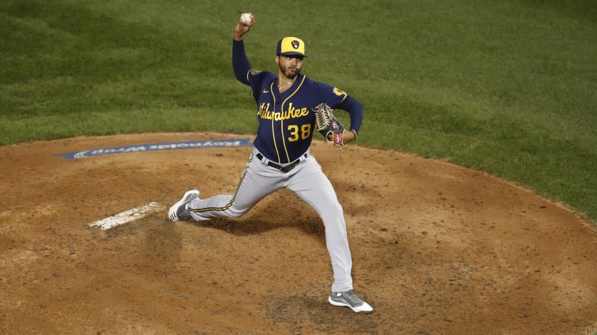 Milwaukee Brewers relief pitcher Devin Williams (38) delivers during a baseball game against the Chicago Cubs Friday, Aug. 14, 2020, in Chicago. (AP Photo/Jeff Haynes)