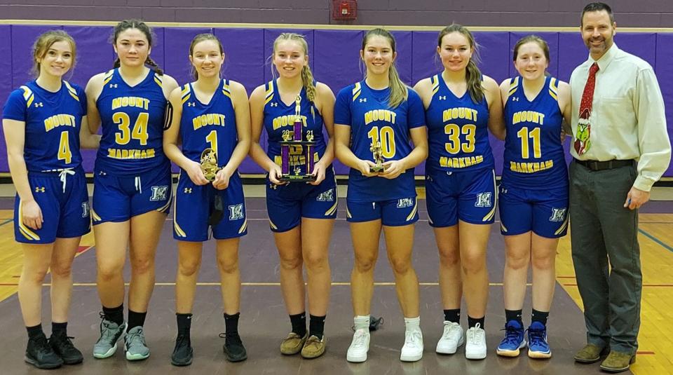 The Mt. Markham Mustangs pose with their hardware after beating Central Valley Academy in the championship game at the Richfield Springs Holiday Tournament Thursday.