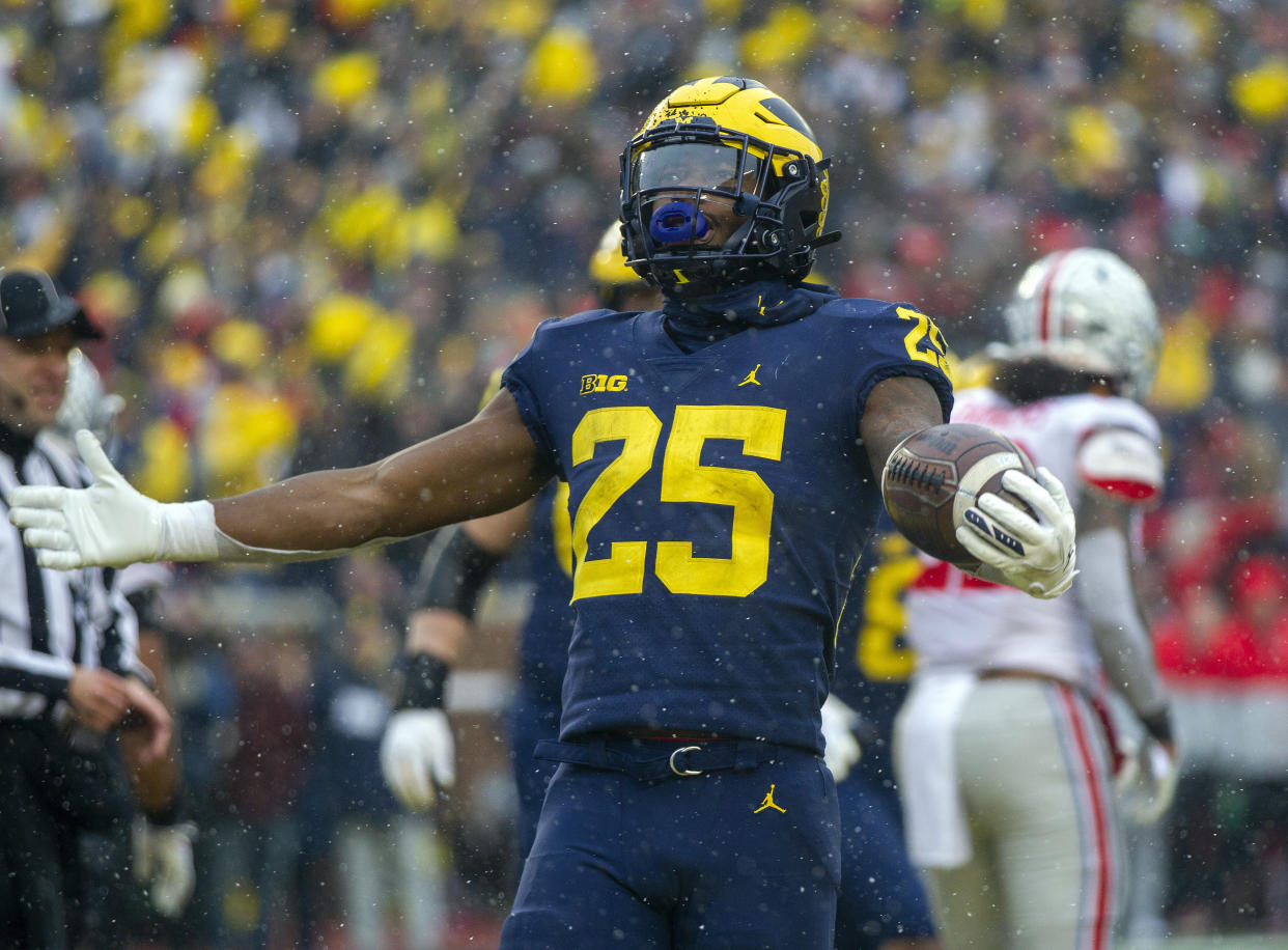 Michigan running back Hassan Haskins (25) celebrates a touchdown in the fourth quarter of an NCAA college football game against Ohio State in Ann Arbor, Mich., Saturday, Nov. 27, 2021. Michigan won 42-27. (AP Photo/Tony Ding)