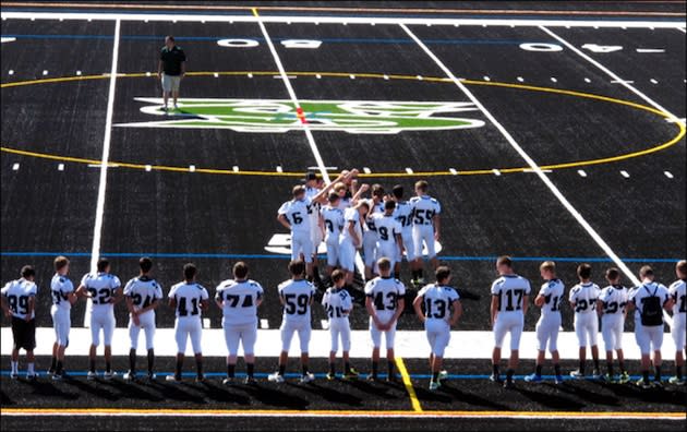 West Salem's football team on the school's unique new black field — AP