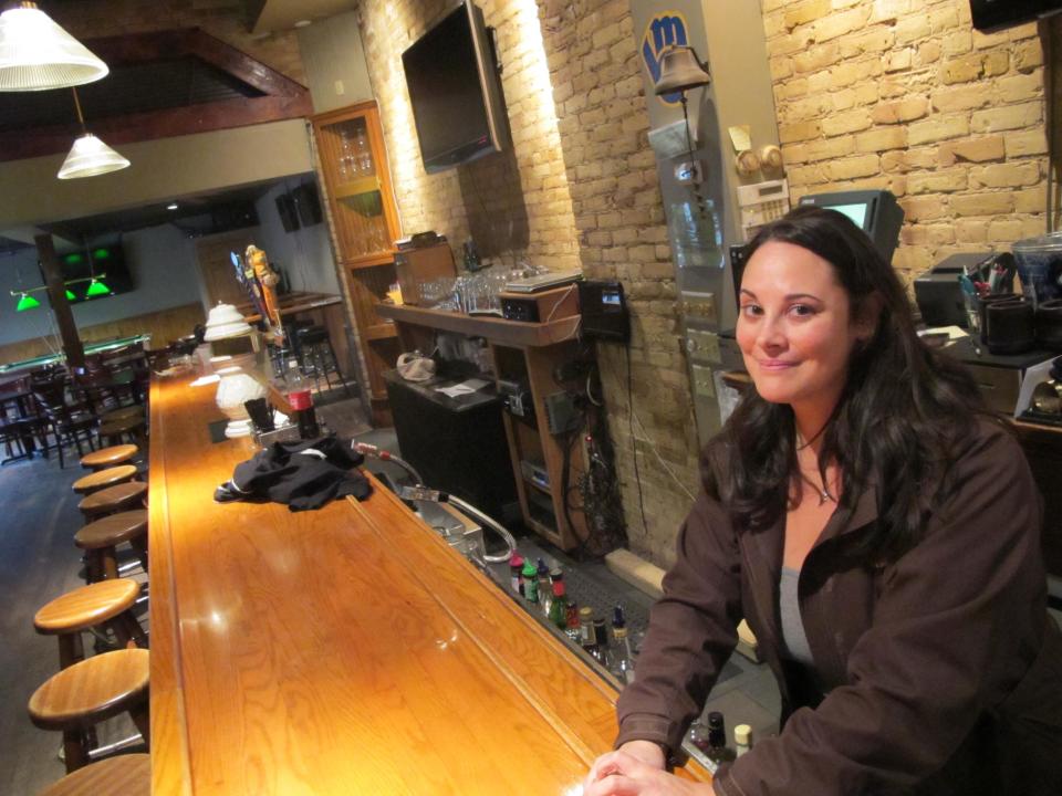 FILE - In this March 1, 2012, file photo is Sara Drescher, manager at 5th Ward Pub in the Milwaukee, Wis., neighborhood where a marketing company is organizing a walking tour of bars where serial killer Jeffrey Dahmer hunted his victims. Bam Marketing and Media, which is offering the tours, has offered to donate some proceeds to a charity that supports the parents of murder victims, but that group said Tuesday, March, 6, 2012, it wants no part of it. (AP Photo/Carrie Antlfinger, File)