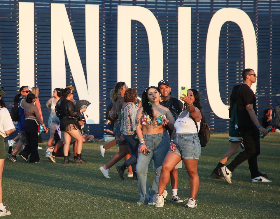 People take photos near the Indio Central Market during the second weekend of the Coachella Valley Music and Arts Festival in Indio, Calif., April 20, 2024.